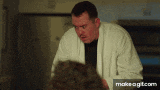 a man in a white robe is standing next to another man in a black shirt