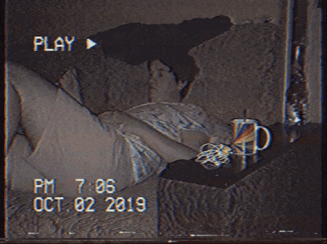 a video of a man laying on a bed with the date of oct 02 2019
