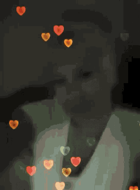 a blurry picture of a woman with hearts floating around her
