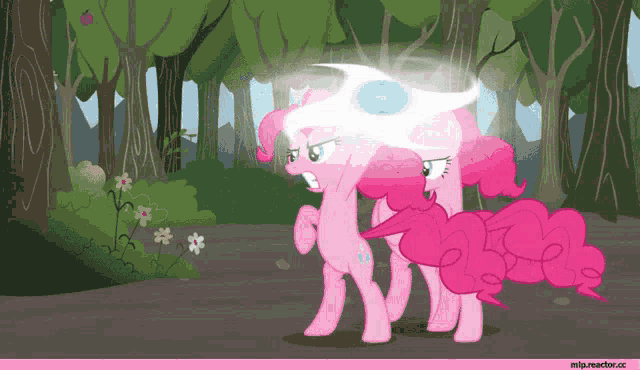 two pink ponies standing next to each other in the woods