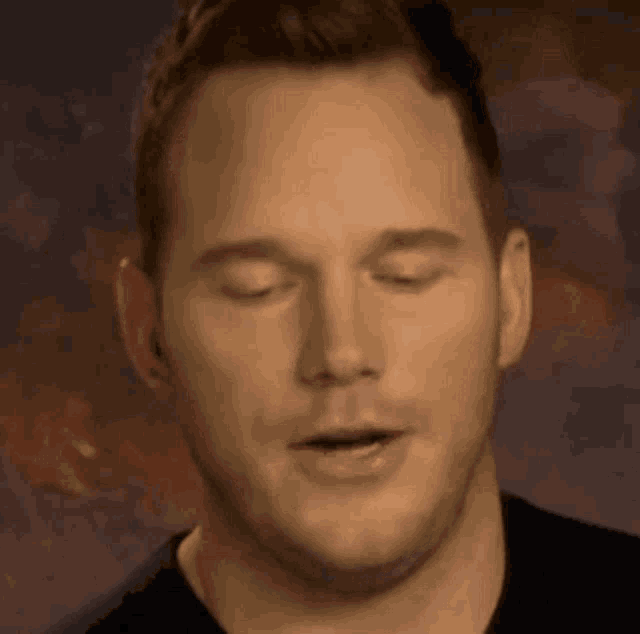 a close up of a man with his eyes closed .