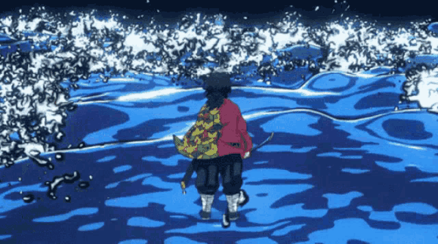 a man in a red cape is walking in the ocean