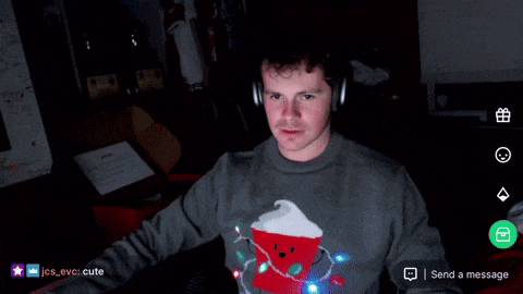 a man wearing headphones and a sweater with a santa hat on it