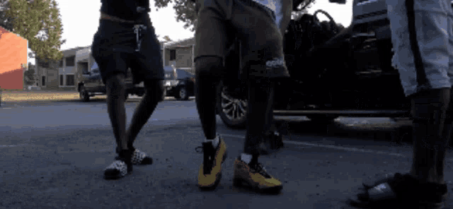 a group of people are standing in a parking lot with one wearing a short that says ' ecg ' on it