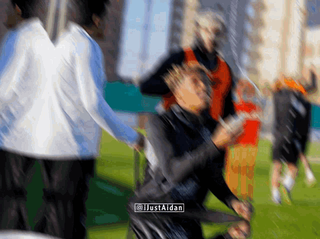 a blurry picture of people on a field with the watermark @justaidan
