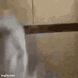 a close up of a person holding a knife in a bathroom .