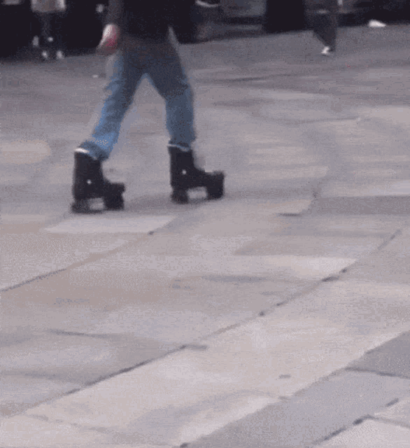 a person wearing roller skates on a sidewalk