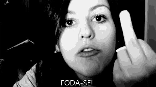 a woman is making a funny face and giving the middle finger in a black and white photo .