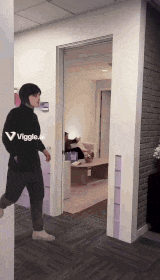 a man wearing a black sweater that says viggle on it