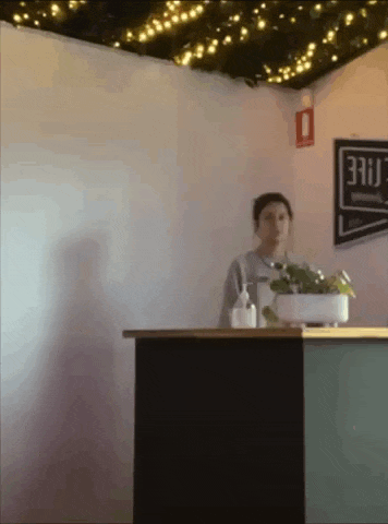 a woman stands at a counter in front of a sign that says ' free '