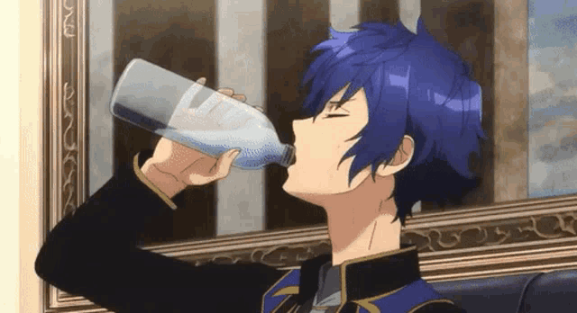 a boy with blue hair is drinking water from a plastic bottle