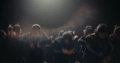 a group of people with their arms in the air
