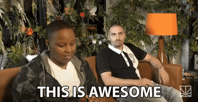 a man and a woman are sitting on a couch with the words this is awesome above them