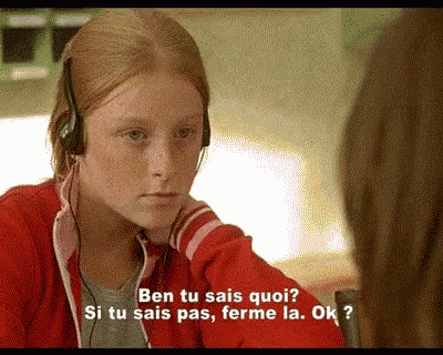 a girl wearing headphones talks to another girl in french