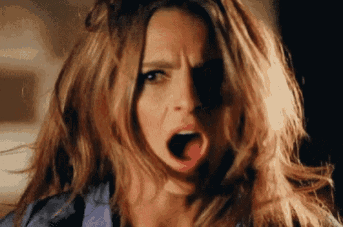 a close up of a woman making a funny face with her mouth open