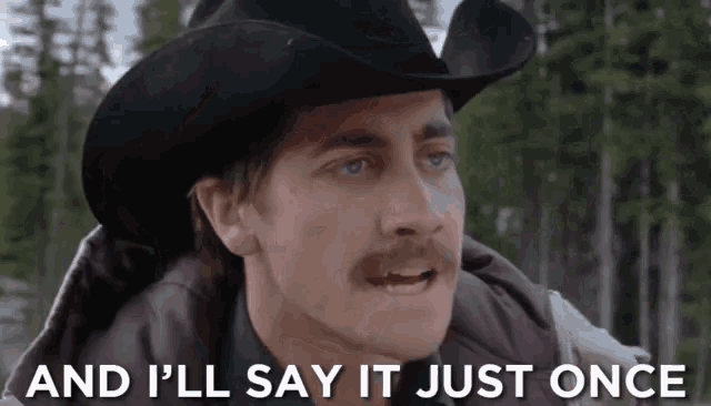 a man with a cowboy hat and a mustache says and i 'll say it just once