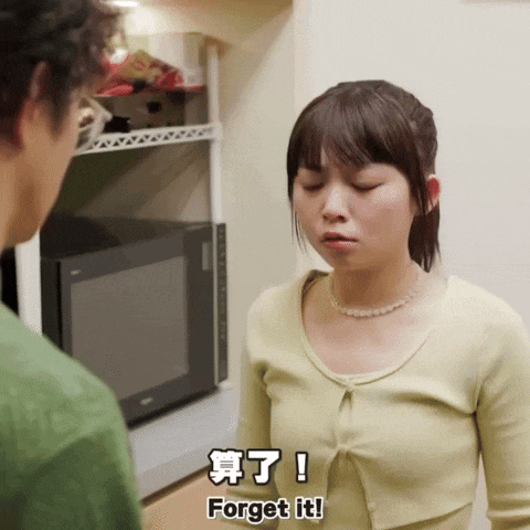 a woman stands in front of a microwave while a man says " forget it "