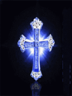 a green cross with diamonds on it is lit up in the dark .