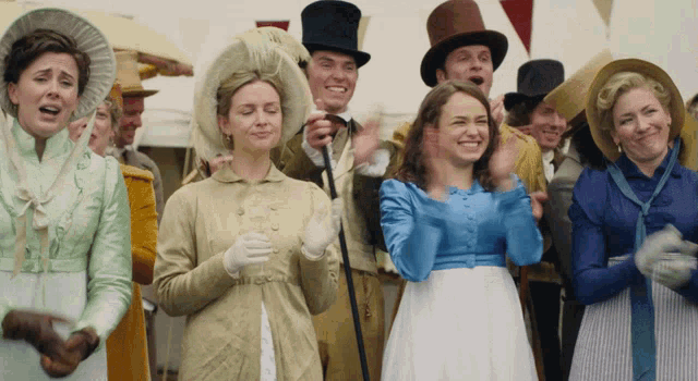 a group of people wearing top hats and gloves applauding
