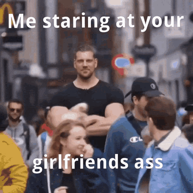 a man in a black shirt is staring at a woman in a crowd