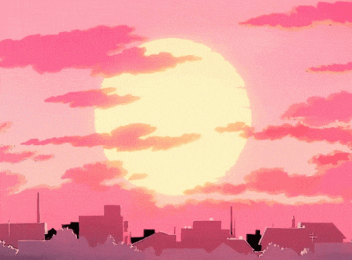 a sunset over a city with the sun shining brightly