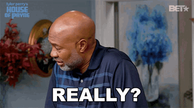 a man in a blue shirt is saying really