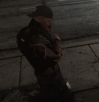 a man wearing a hat and a vest that says police