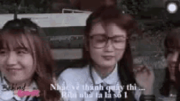 a group of young women are standing next to each other .