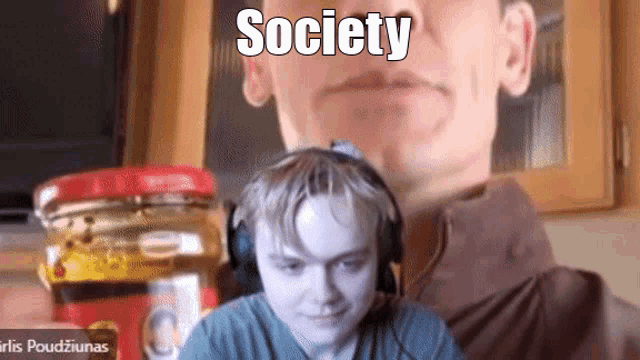 a man wearing headphones is looking at a jar of peanut butter
