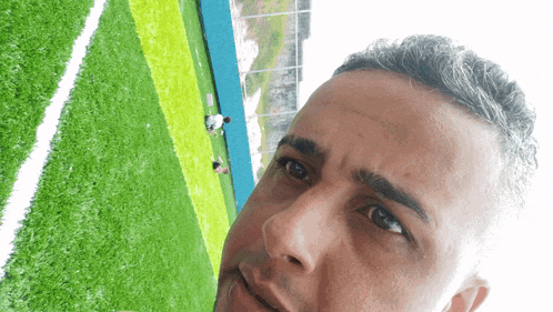 a man standing in front of a soccer field