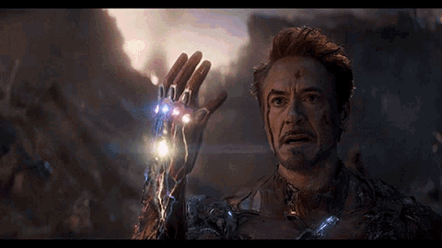 a man with a beard is holding a glowing object in his hand