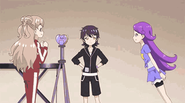 a girl with purple hair is standing next to another girl
