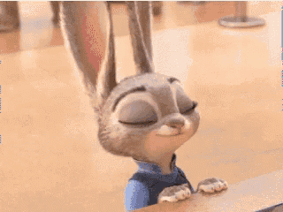 a cartoon rabbit is sitting on a wooden table with its ears spread out .