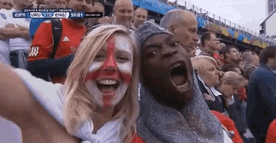 a man and a woman with their faces painted in the colors of the england flag