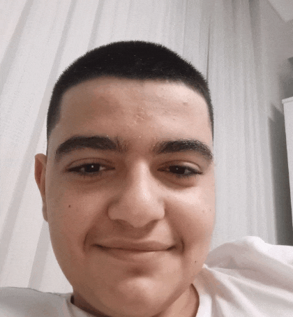 a close up of a man 's face with a shaved head