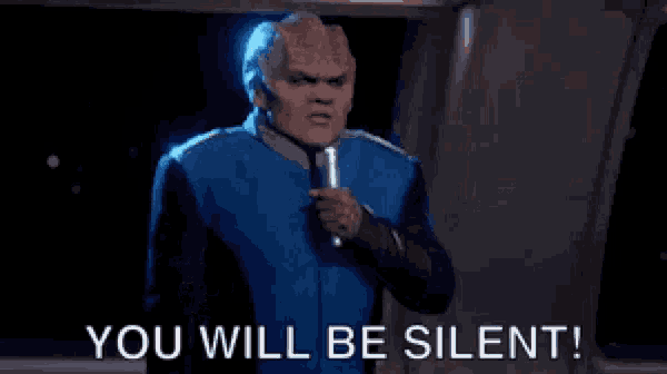a man is holding a microphone and saying you will be silent .