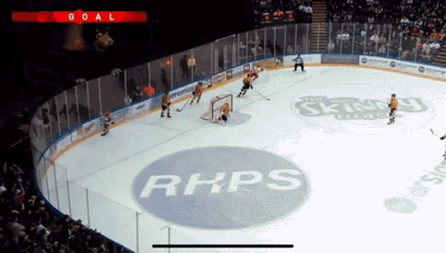 a hockey game is being played on a rink with a logo for rhps