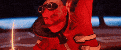 a man with a mustache and goggles on his head