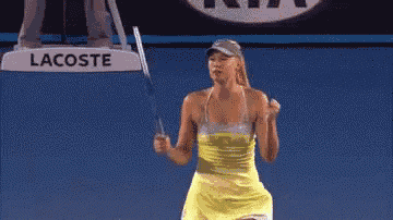 a woman in a yellow dress is holding a tennis racquet in front of a lacoste sign