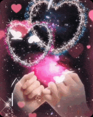 a couple of hands holding a pink heart with hearts and butterflies around it .