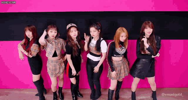 a group of girls standing next to each other with a pink background that says honeycam on it