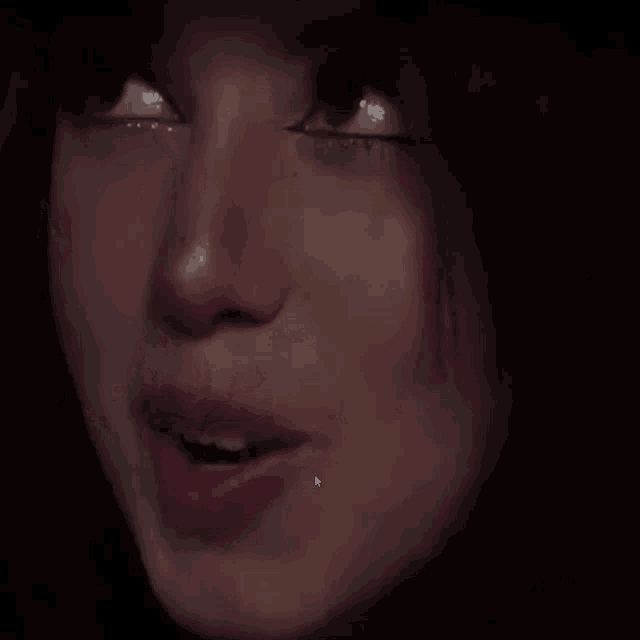 a close up of a woman 's face with a cursor pointing to her mouth