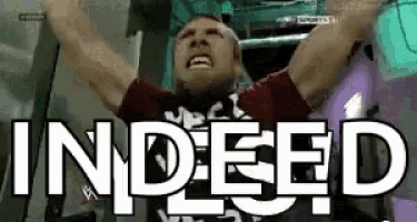 a man is screaming with his arms in the air and the word indeed is on the screen .