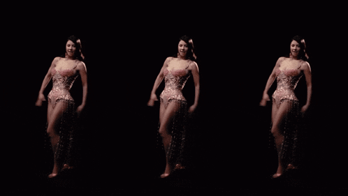 a woman in a dress is dancing in the dark