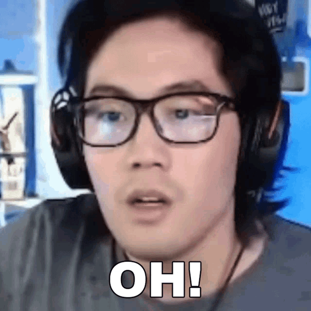 a man wearing glasses and headphones is making a funny face and saying `` oh ! ''
