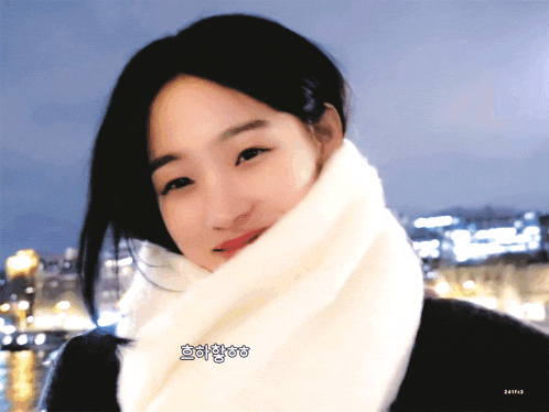 a woman wearing a white scarf is smiling and has a sticker that says ' netflix ' on the bottom