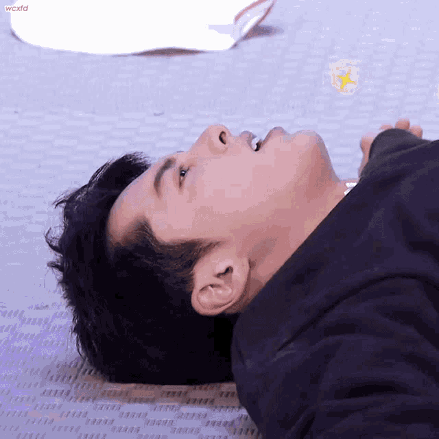 a close up of a man laying on the floor with the word world visible