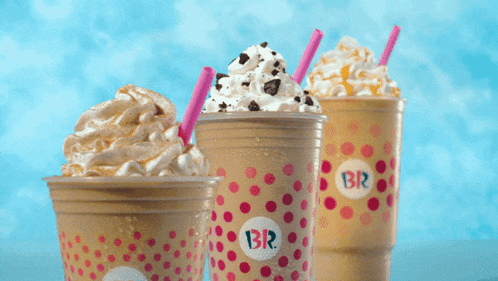 three cups of milkshakes with br on them