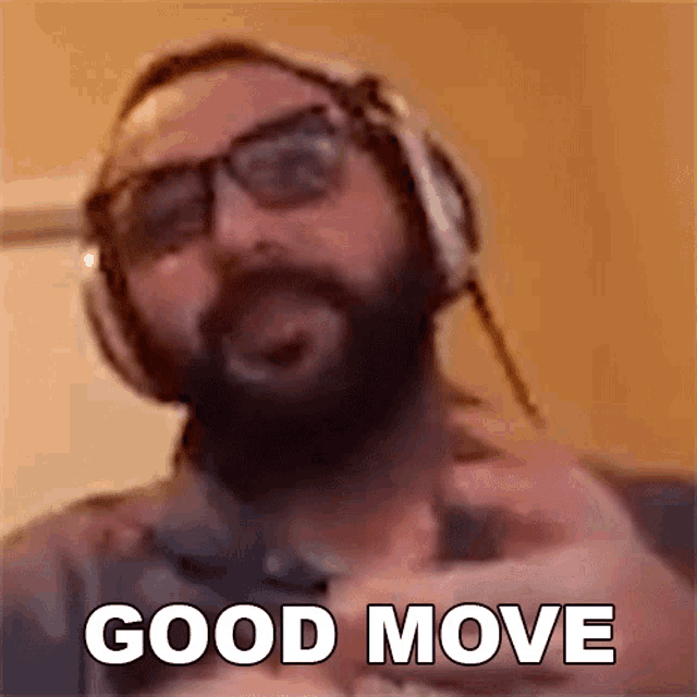 a man with a beard wearing headphones and glasses is giving the middle finger .