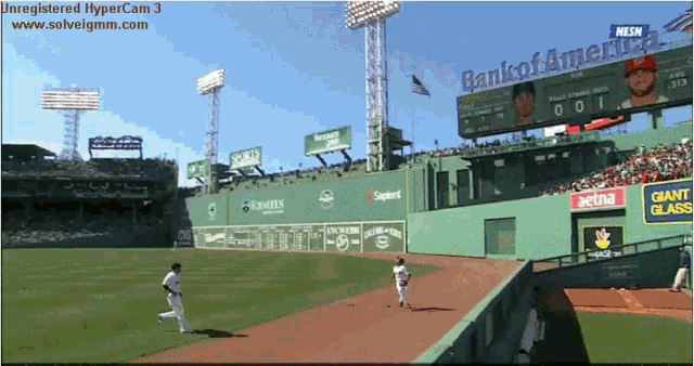 a baseball game is being played in a stadium with a bank of america billboard in the background